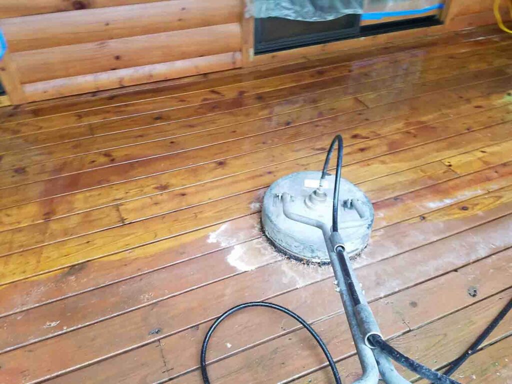 scrubbing a patio before applying wood sealer