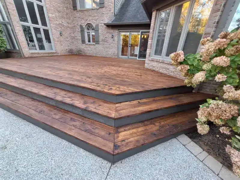 Freshly stained and sealed wood deck with dark trim by Seal Now Indianapolis