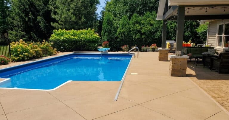 Stained concrete pool deck surrounding an inground pool at an Indianapolis home