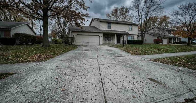 Aging concrete driveway showing cracks and weathering in an Indianapolis neighborhood