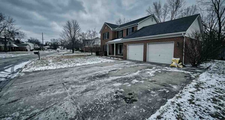 Indianapolis driveway in winter showing road salt residue and early concrete damage