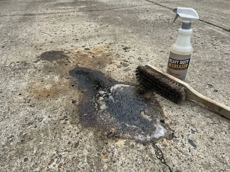 Removing an oil stain during concrete cleaning in Indianapolis