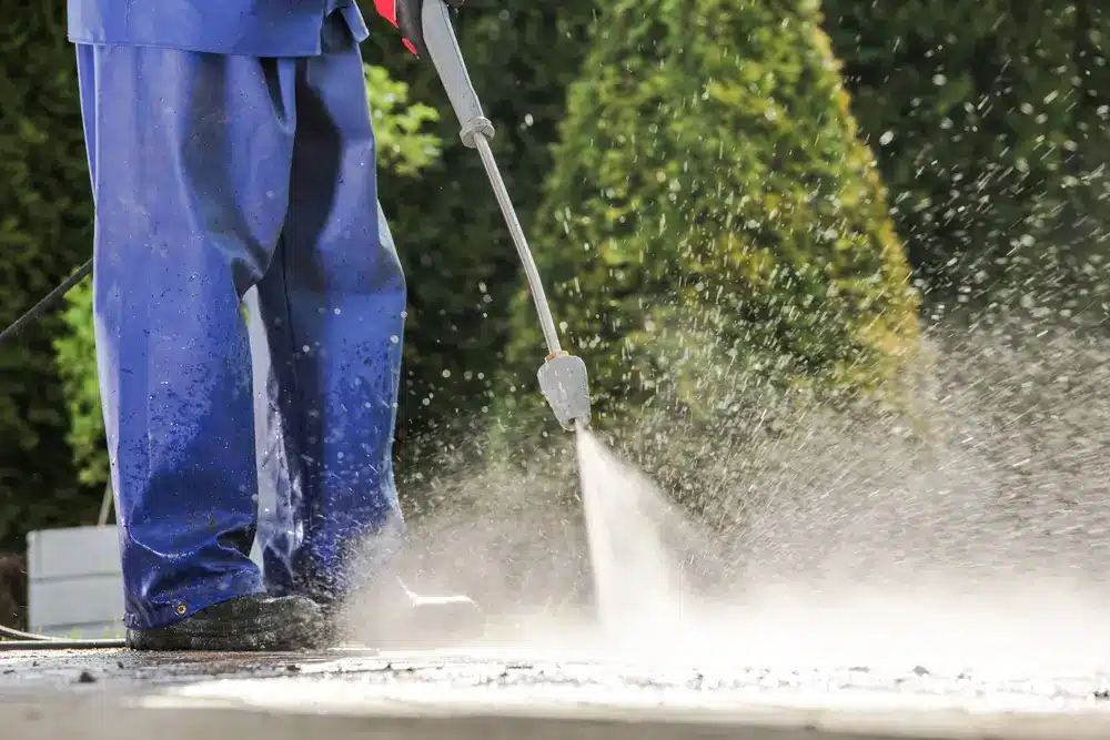 Pressure washing an Indianapolis concrete driveway to prep the surface for sealing